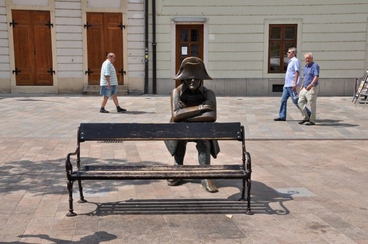 Downtown Bratislava Napoleon's Army brass soldier on a park bench.