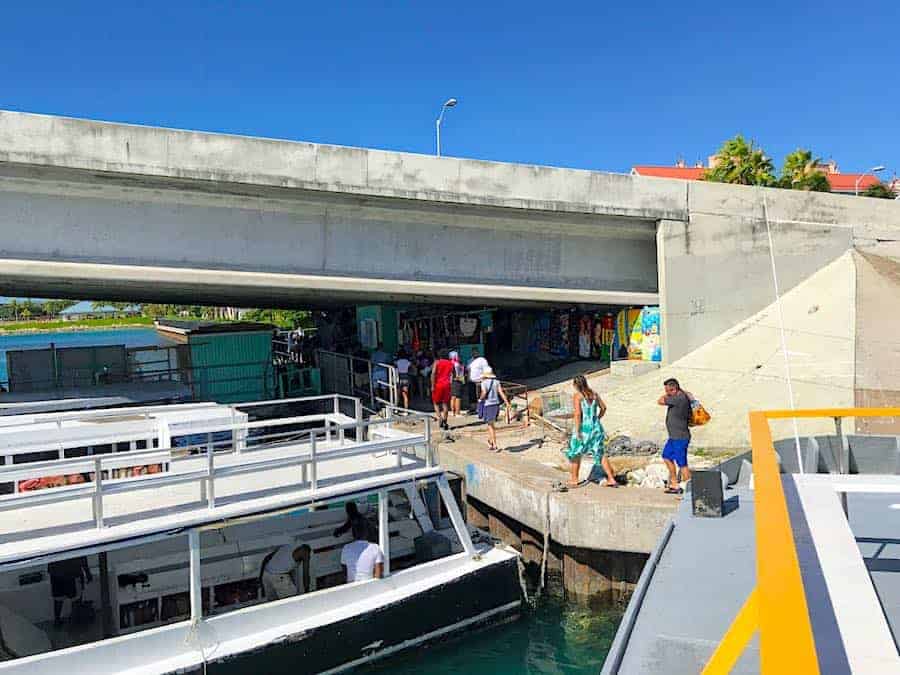 People leaving the ferry boat to walk towards Atlantis Resort from the ferry boat dock.