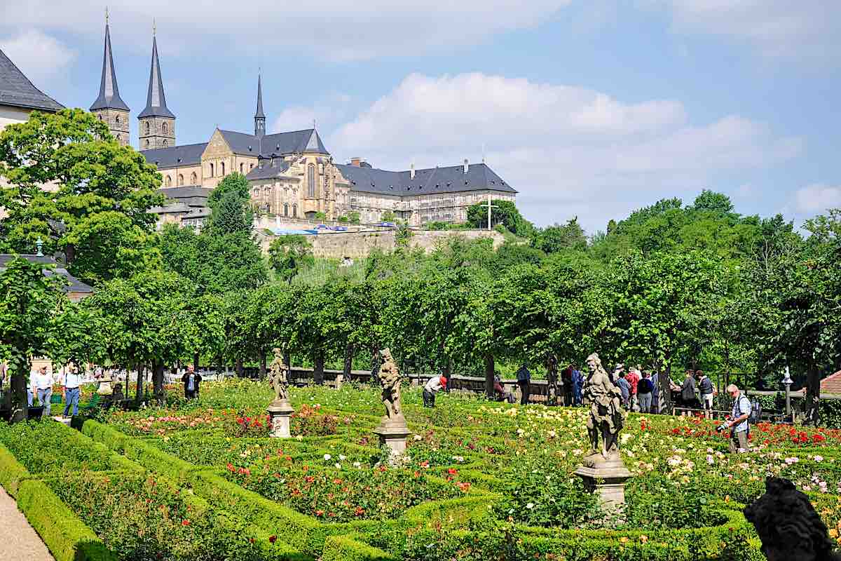 Rose garden in Bamberg, Germany with tourists walking around.