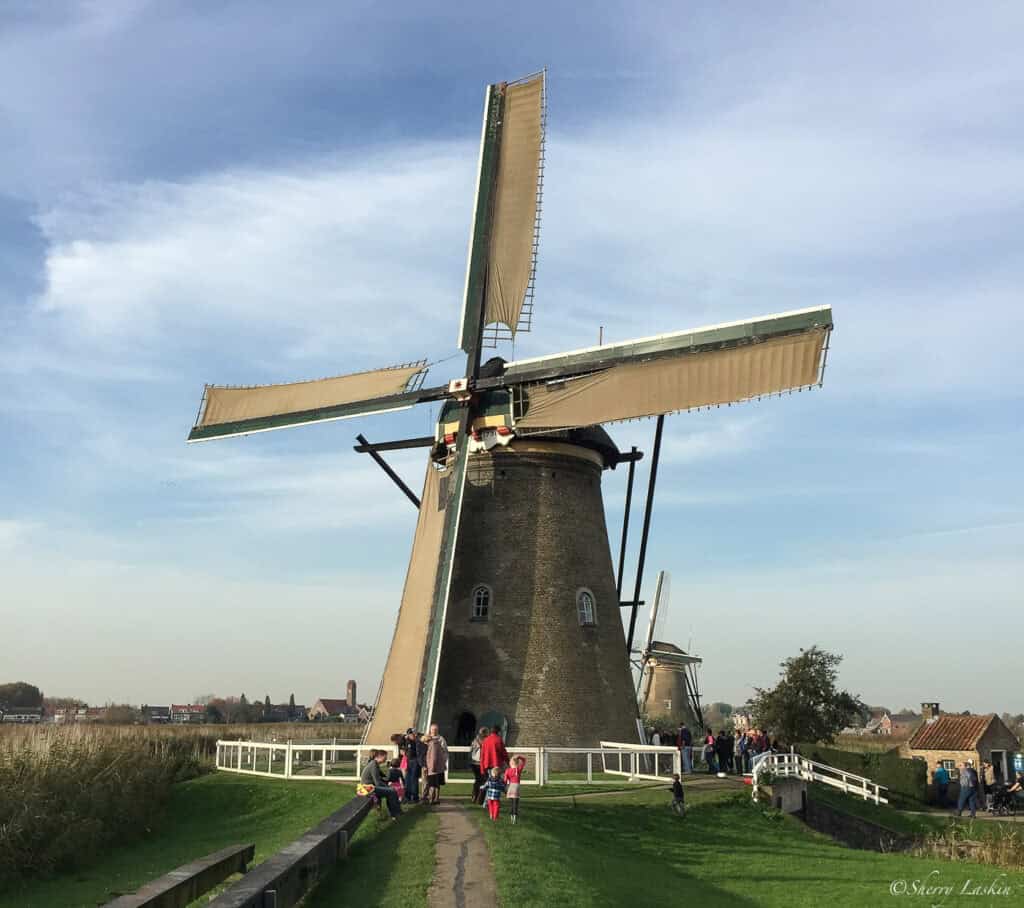 Kinderdijk windmill with tourists milling around.