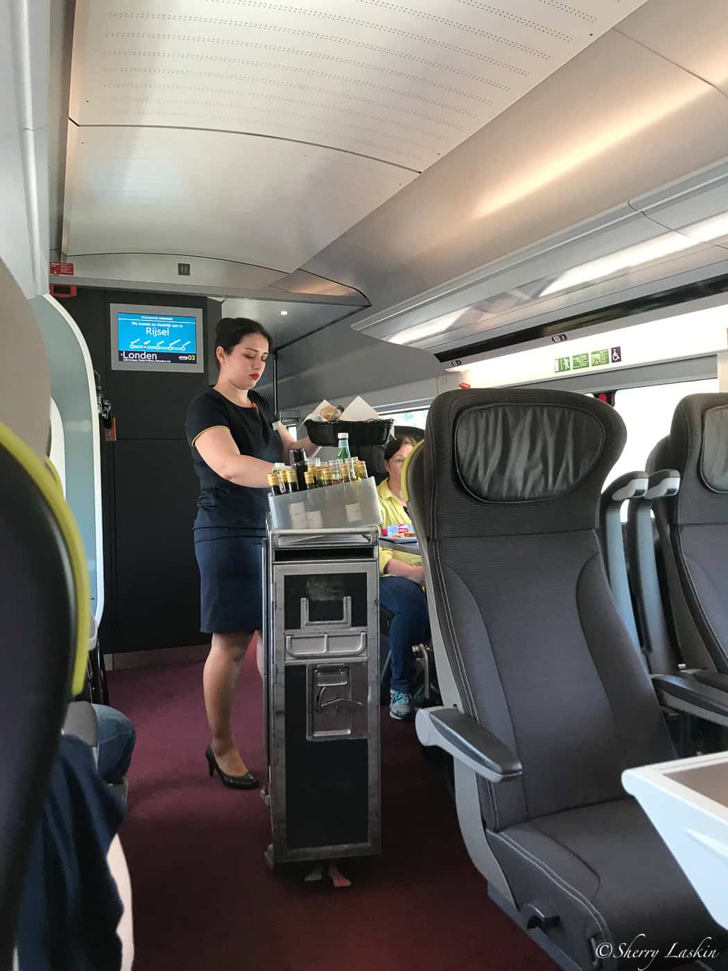 Food service by attendant onboard Eurostar train.