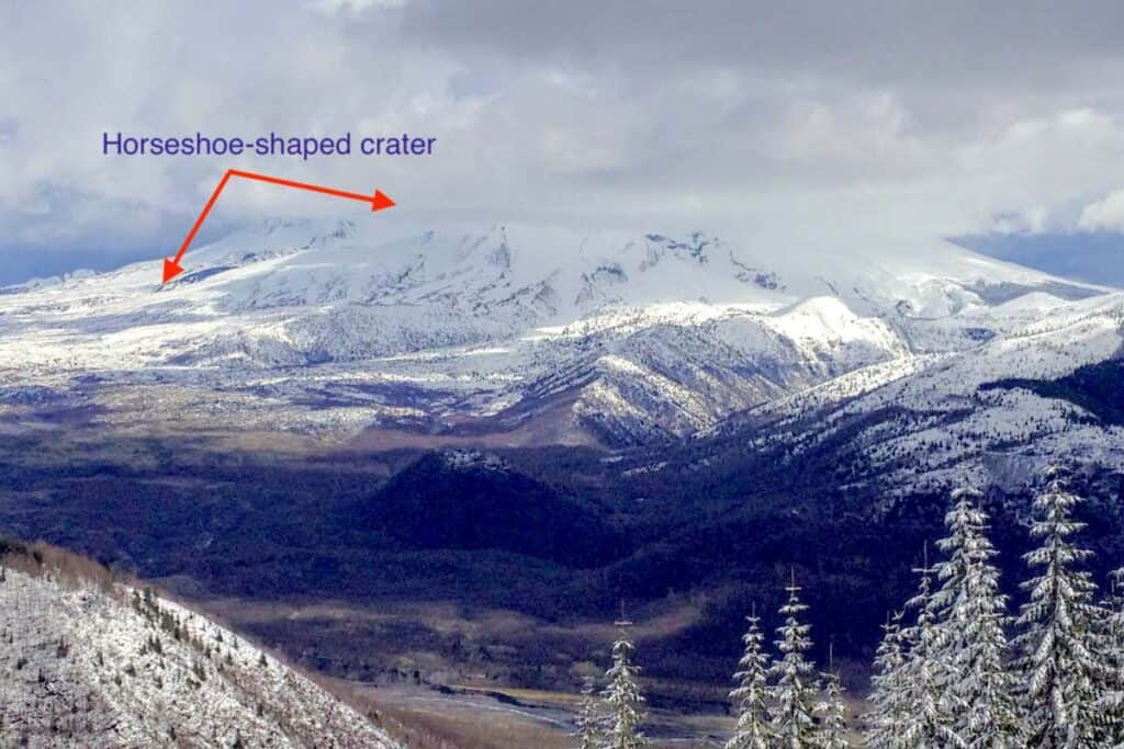 Mount St. Helens with arrows pointing towards the open crater.