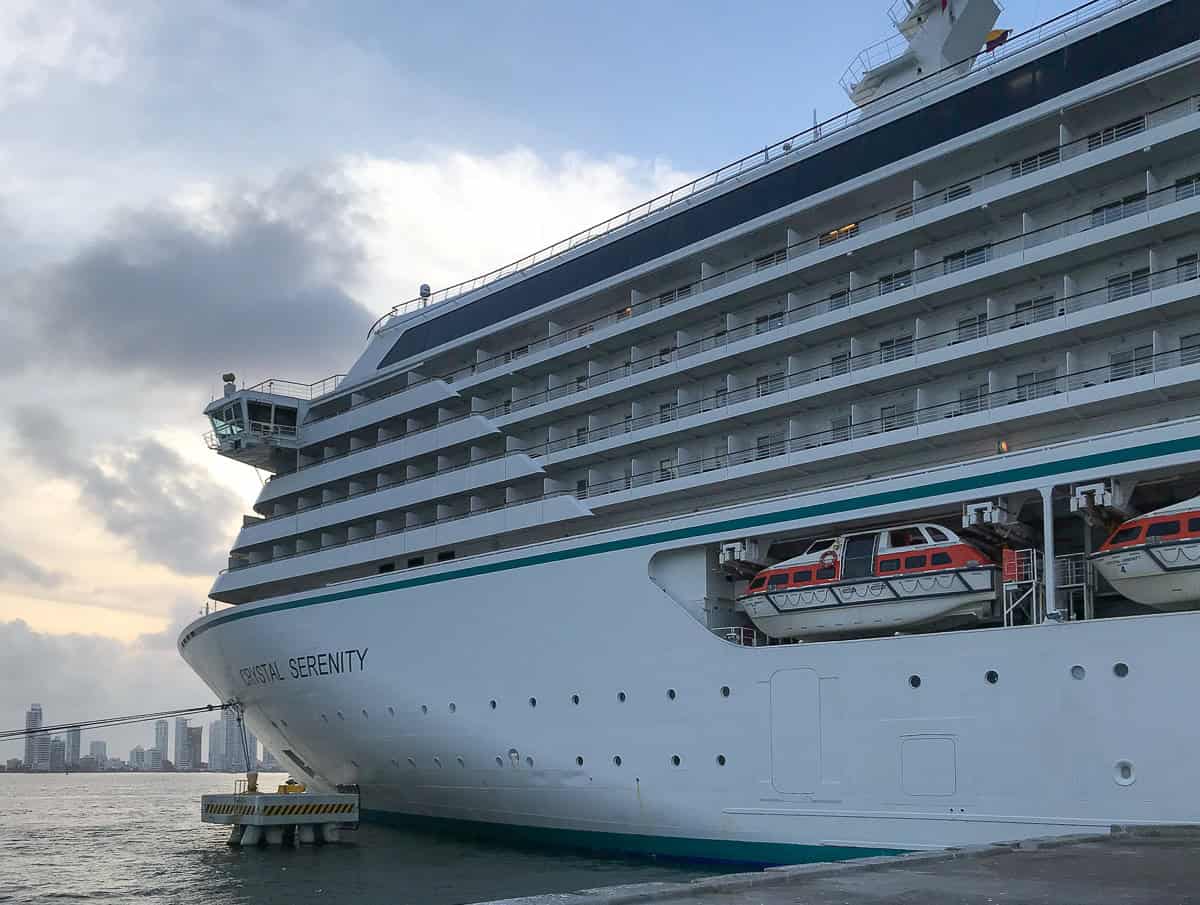 Crystal Serenity docked in Cartagena with skyline in background.