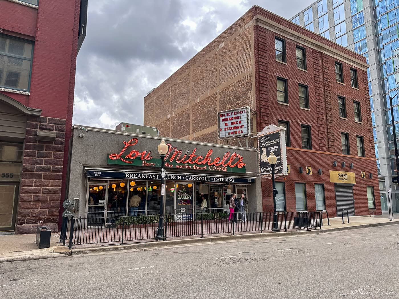 Front entrance to Lou Mitchell's restaurant with name in red neon lilghts.