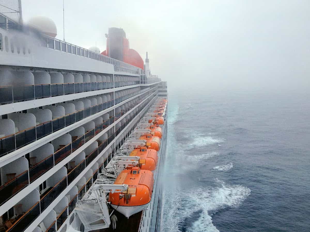 Queen Mary 2 cruise ship at sea in the fog.