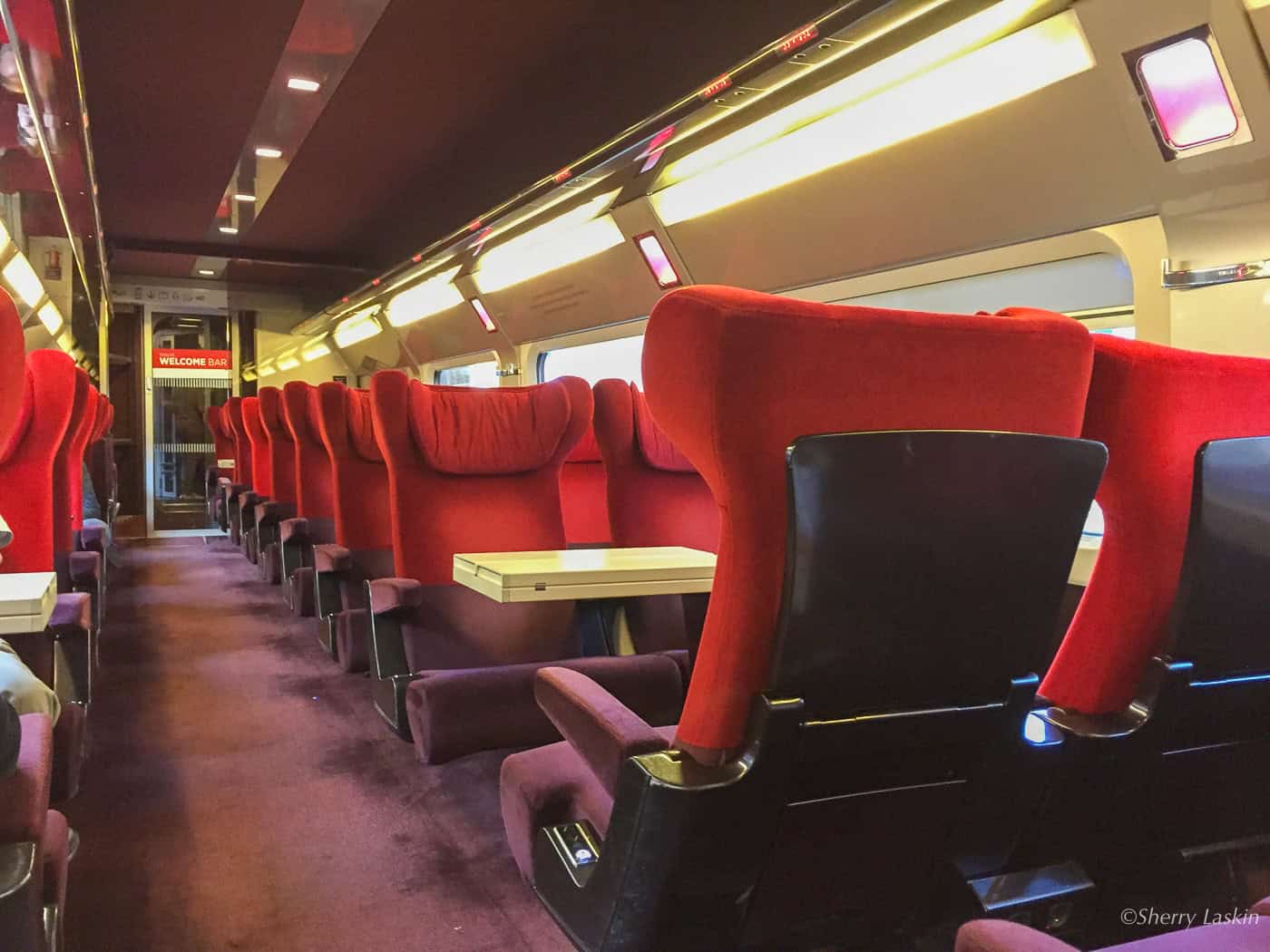 Red and purple seating in First Class on Thalys train from Amsterdam to Paris.